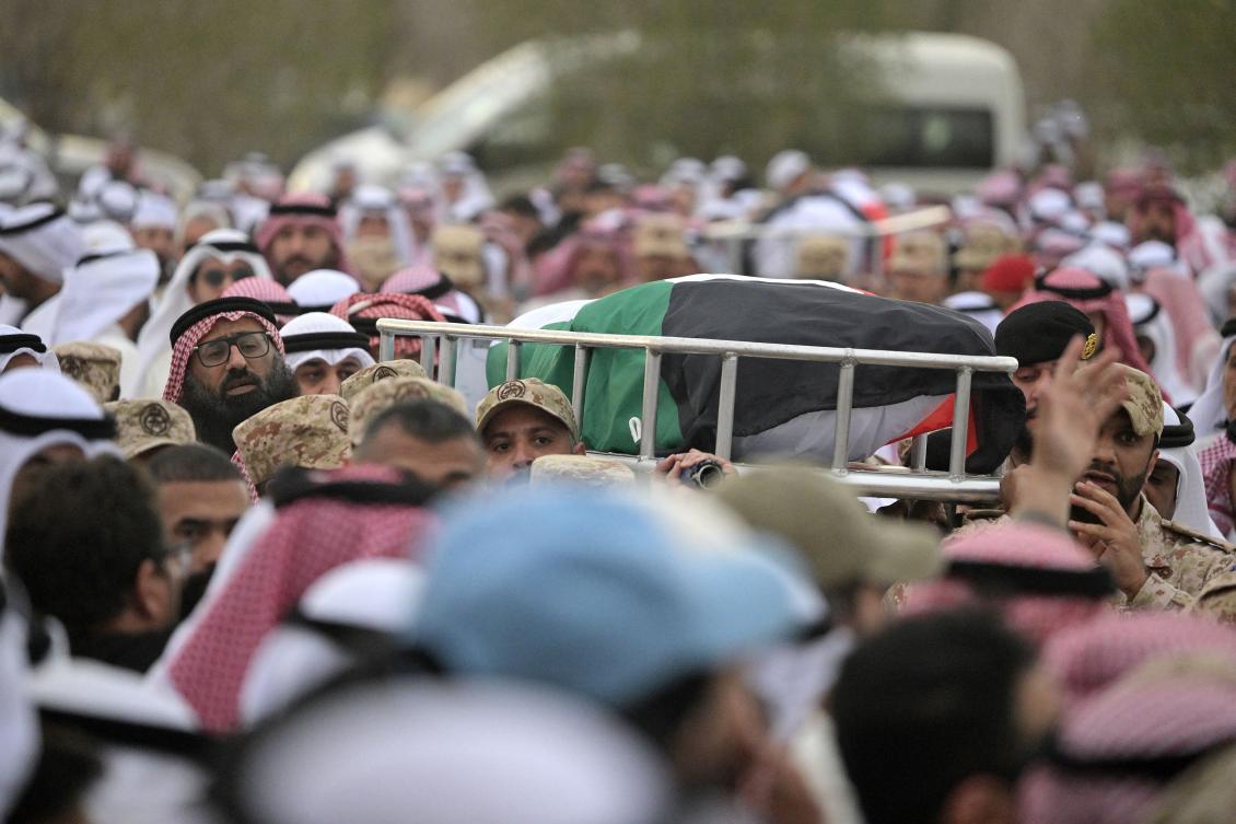 Mourners carry flag draped body of a Kuwait Army members who were killed in an Iranian strike on Kuwait at the Sulaibikhat cemetery, west of Kuwait City on March 3, 2026. The United States and Israel launched strikes against Iran on February 28, with the killing of Iran's supreme leader and the Islamic republic retaliated with barrages of missiles at Gulf states and Israel. (Photo by YASSER AL-ZAYYAT / AFP)