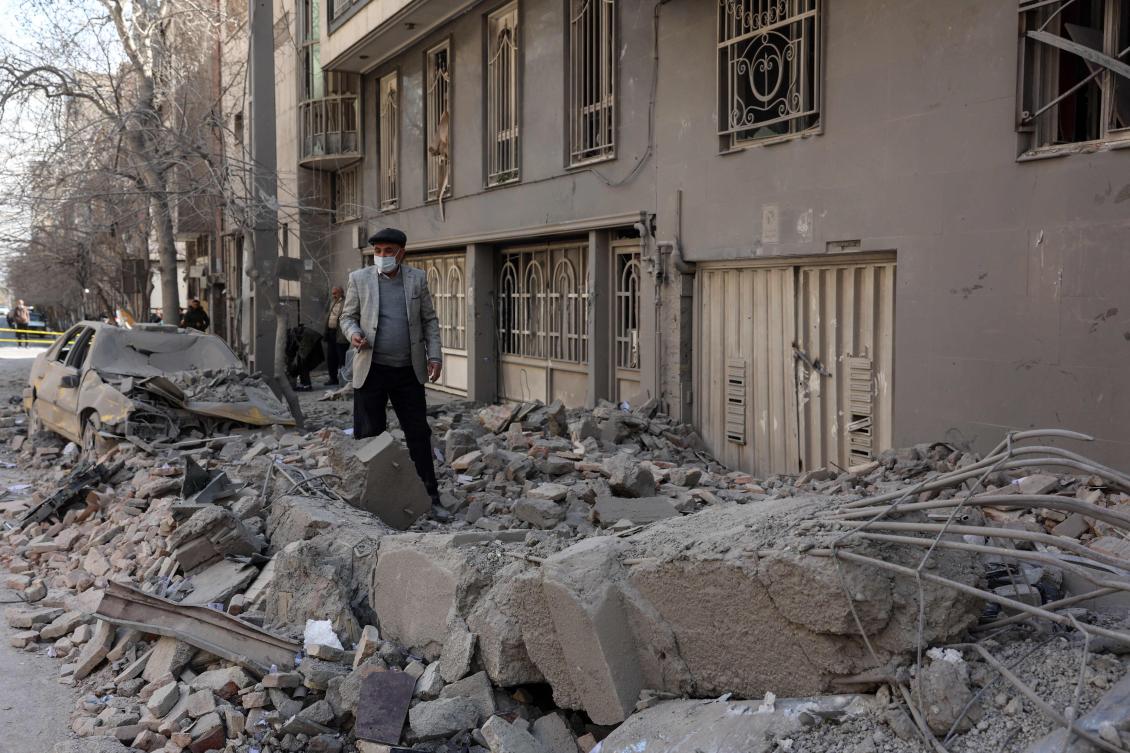 A man makes his way through debris littering a street following airstrikes in central Tehran, on March 4, 2026. (AFP)
