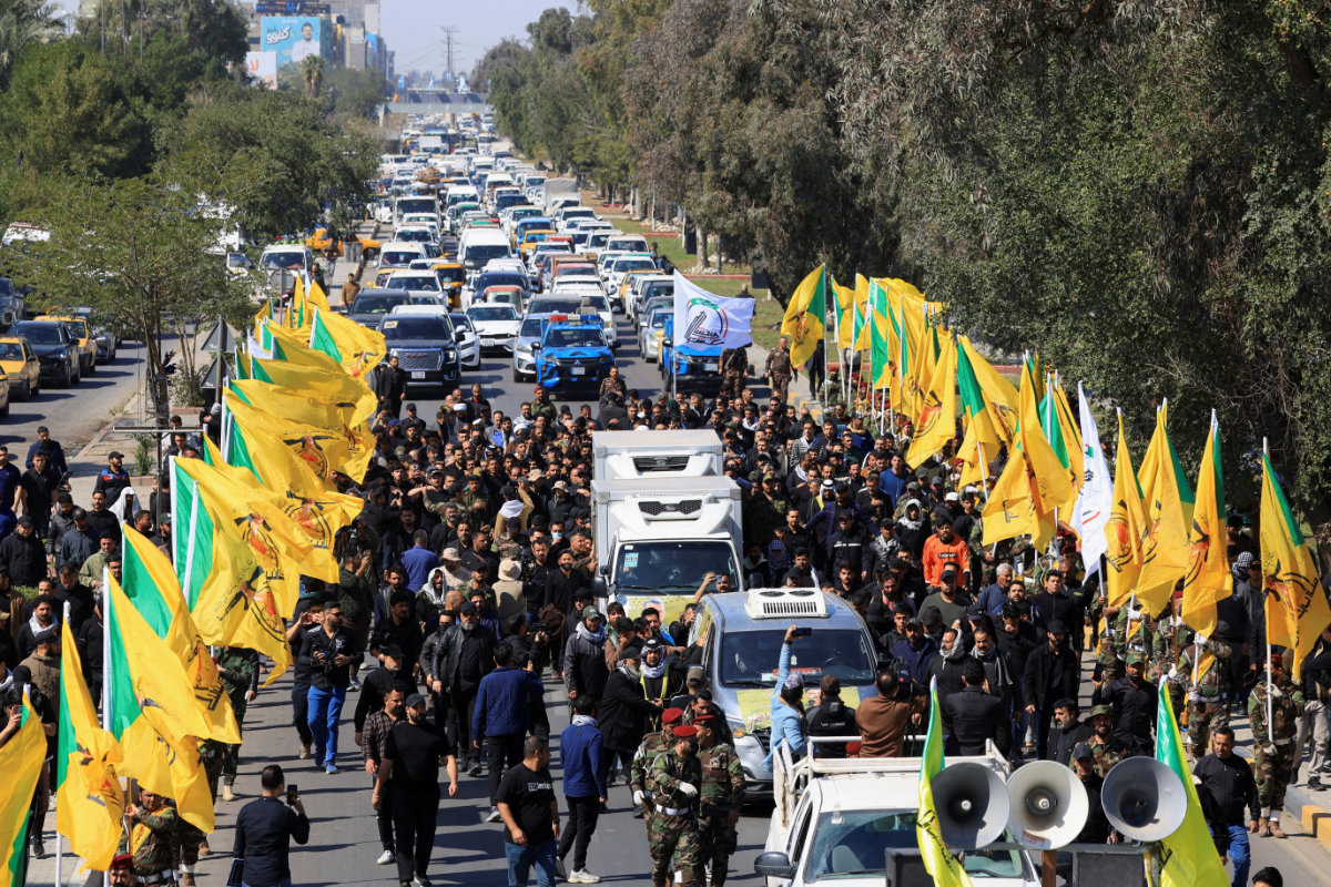 This photo taken on March 2, 2026, in Baghdad, Iraq, shows members of the Iraqi armed group Kataib Hezbollah attending the funeral of their colleagues who were killed in an airstrike that targeted a Hashd al‘Shaabi headquarters near the western al‘Qaim district on the Syrian border, amid the US-Israel conflict with Iran. (REUTERS)