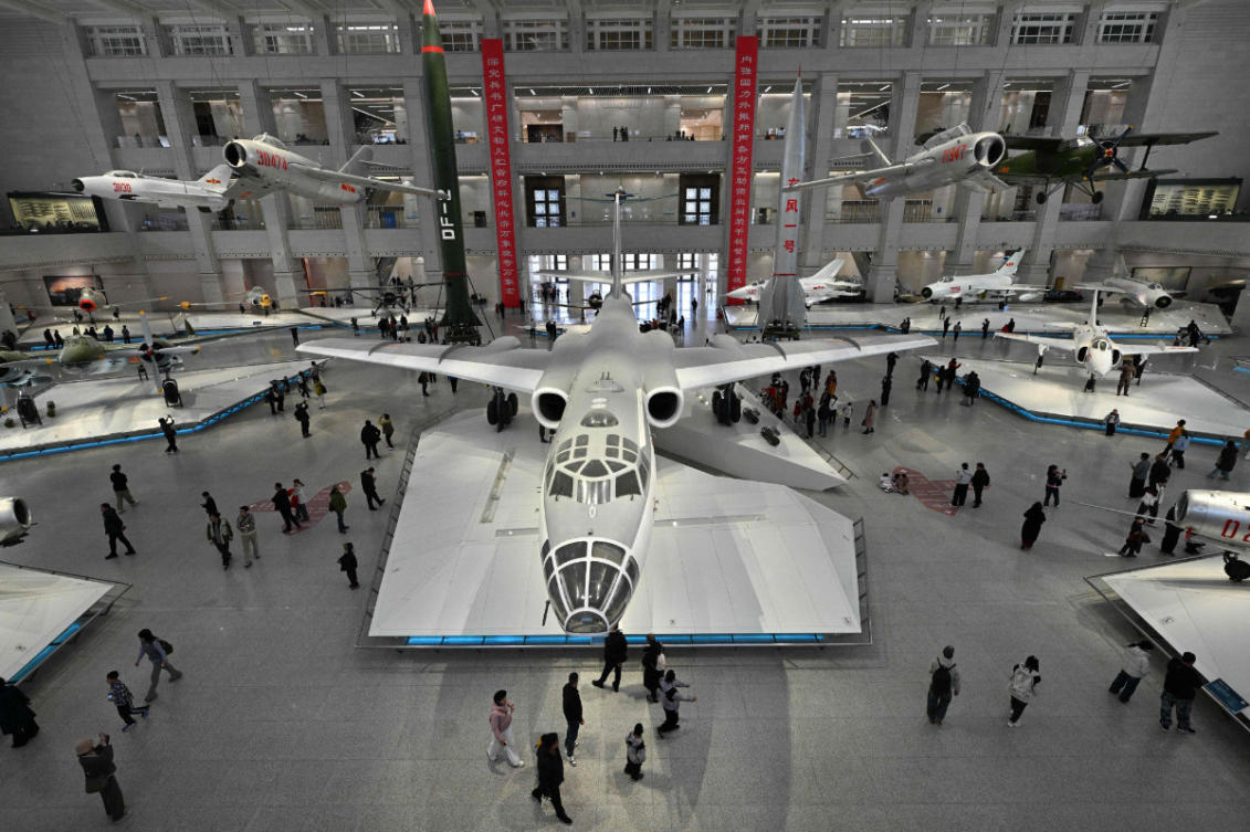 Visitors walk past Chinese People's Liberation Army Air Force aircraft on display the Military Museum in Beijing on March 3, 2026, ahead of the opening of the annual session of the National People’s Congress (NPC). (AFP)
