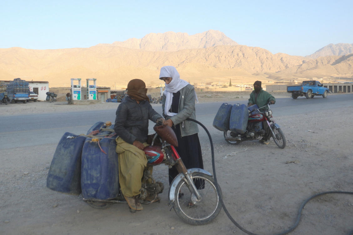 A man on a motorcycle gets his bike refuelled with petrol brought from Iran, amid the U.S.-Israel conflict with Iran, at a roadside depot on the outskirts of Quetta, Pakistan, March 4, 2026. (REUTERS)
