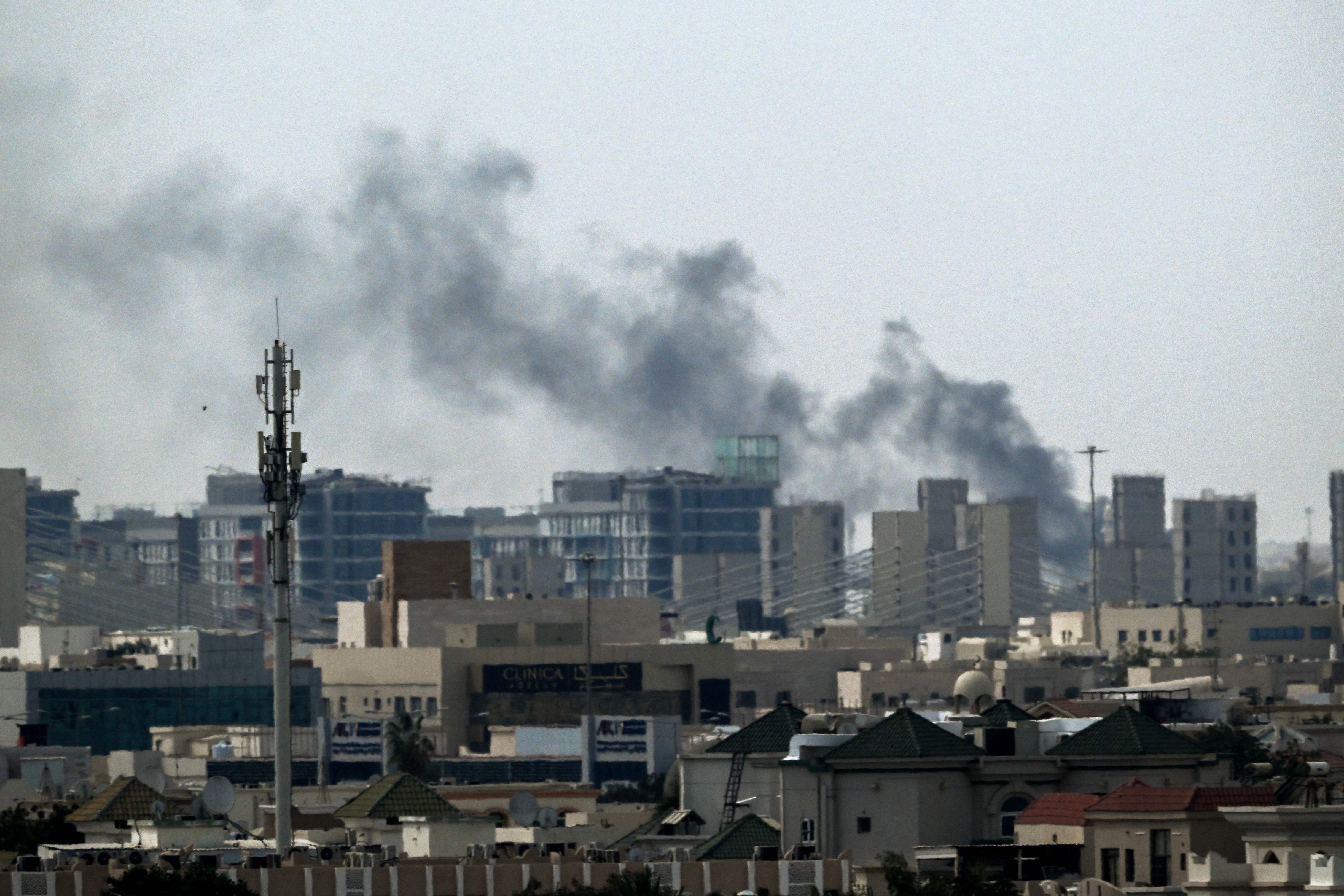 A plume of smoke rises over buildings in Doha on Thursday. (AFP)