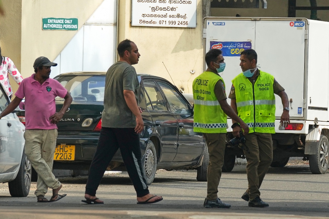 An Iranian sailor, who was rescued from IRIS Dena warship by Sri Lanka's navy, is escorted to a Judicial Medical Officer from the National Hospital in Galle, Sri Lanka. (AP)