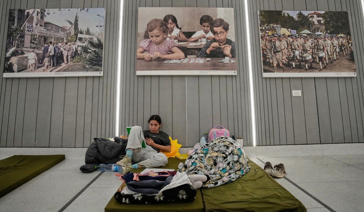 People take shelter in an underground metro station as air raid sirens warn of incoming Iranian missiles in Tel Aviv, Israel, Saturday, March 7, 2026. (AP)