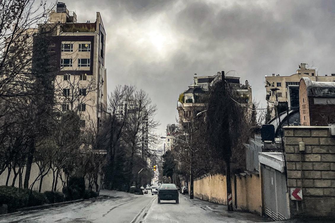 A vehicle moves along a street in a residential area in Tehran on March 8, 2026. (FILE/AFP)