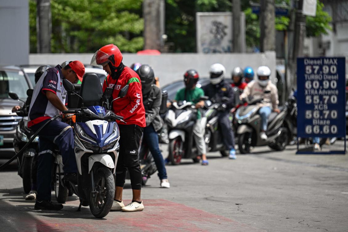 Motorists queue at a gas station amid rising petrol prices in Quezon City on March 9, 2026. There is a plan to reduce excise taxes on petroleum products if the price of crude oil breached $80 per barrel. (AFP)