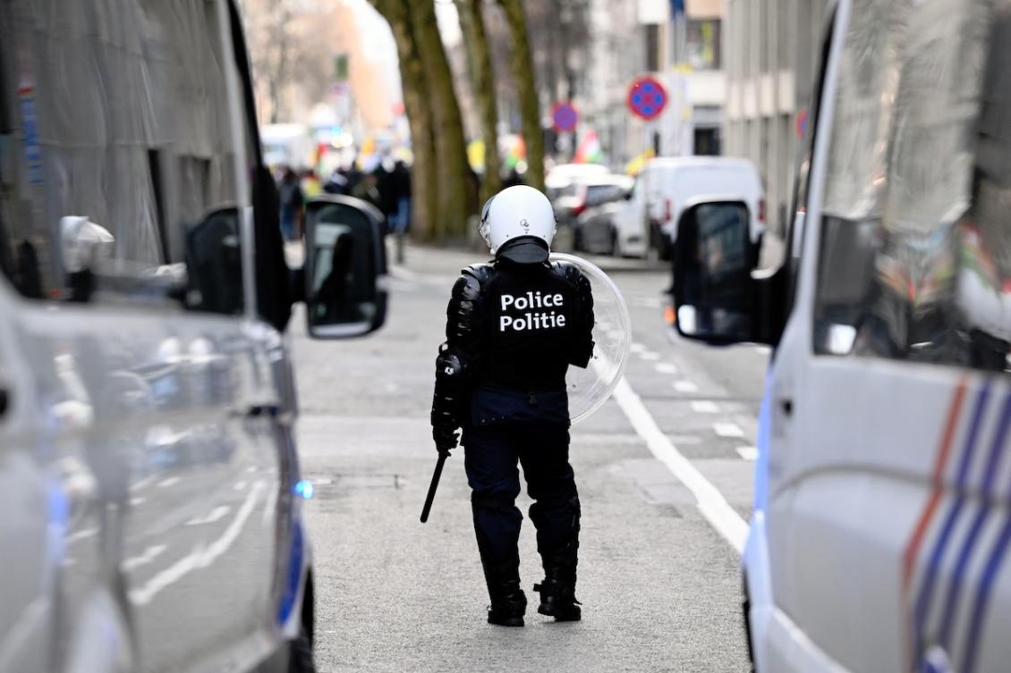 A police officer in riot gear stands on the sidelines of a protest in Brussels on January 21, 2026. (FILE/AFP)