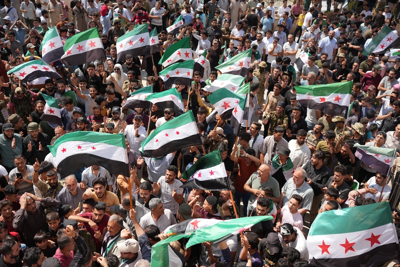 Syrians rally in the northern city of Azaz on August 25, 2023 in support of protests against Bashar Al-Assad’s government in the southern city of Sweida. (File/AFP)