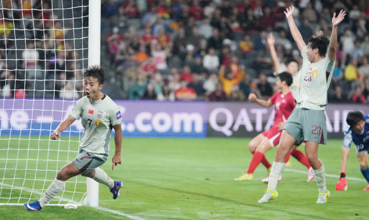 China’s Wang Shuang, left, reacts after scoring her team’s second goal during the Women’s Asian Cup football match between China and North Korea in Sydney Monday. (AP)