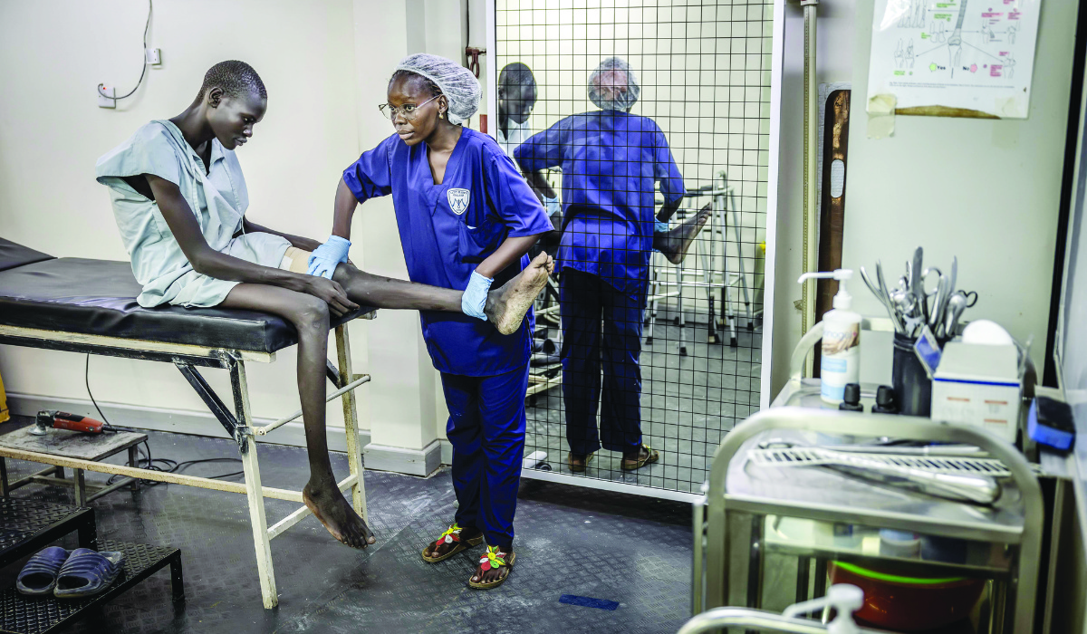 A nurse guides a patient through exercises at a military hospital in Juba. (AFP)