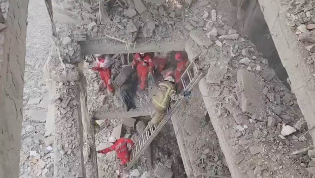 Rescuers work in the rubble of residential buildings after air strikes, in the Resalat neighborhood, in Tehran, Iran. (Handout/Reuters)