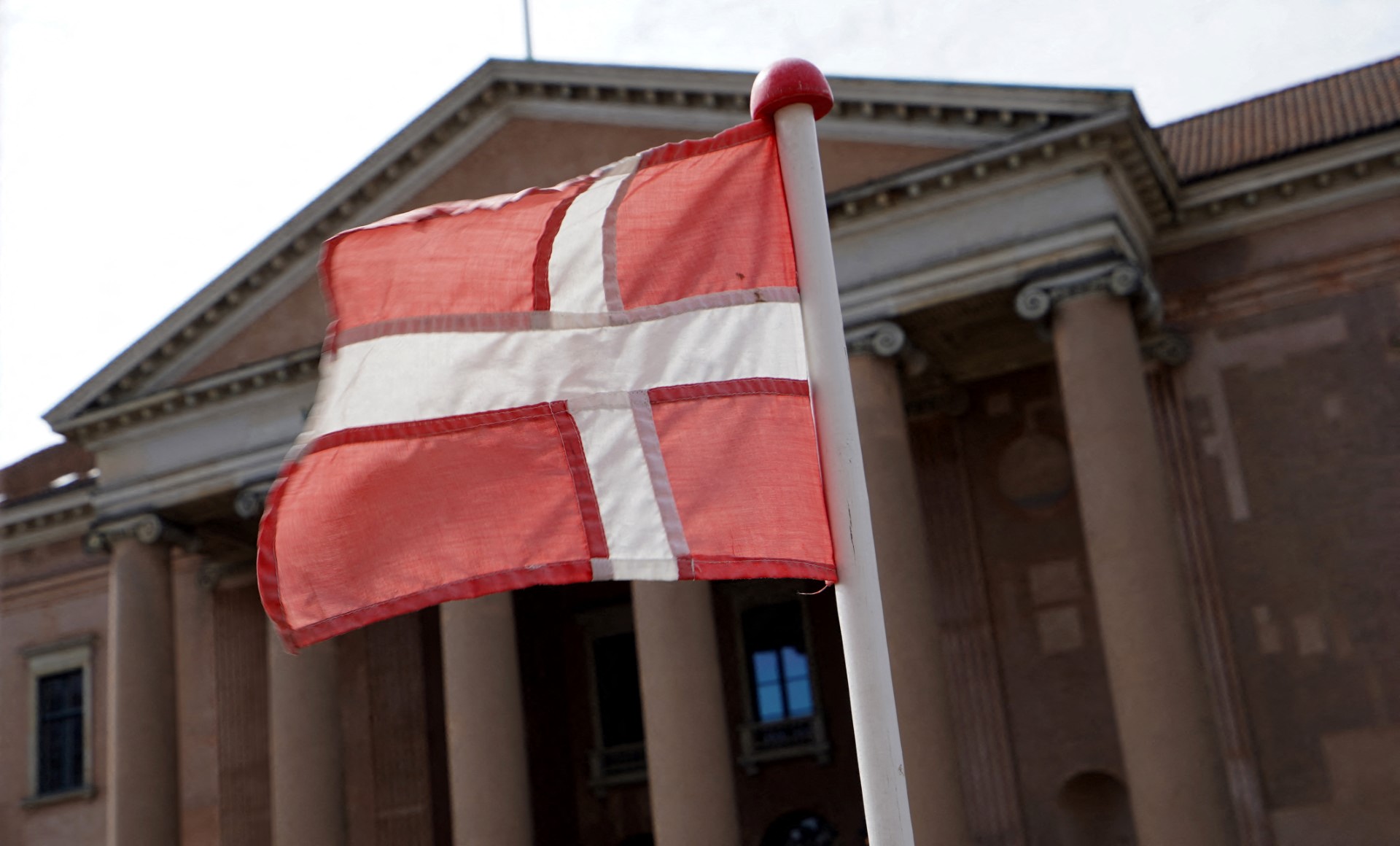 A Danish flag flies in front of Copenhagen Court in central Copenhagen, Denmark, on August 6, 2024. (AFP)