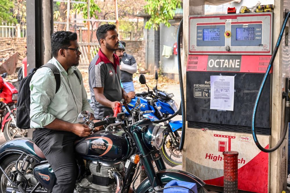 A man gets his motorcycle refueled at a fuel station in Dhaka on March 9, 2026. (AFP)