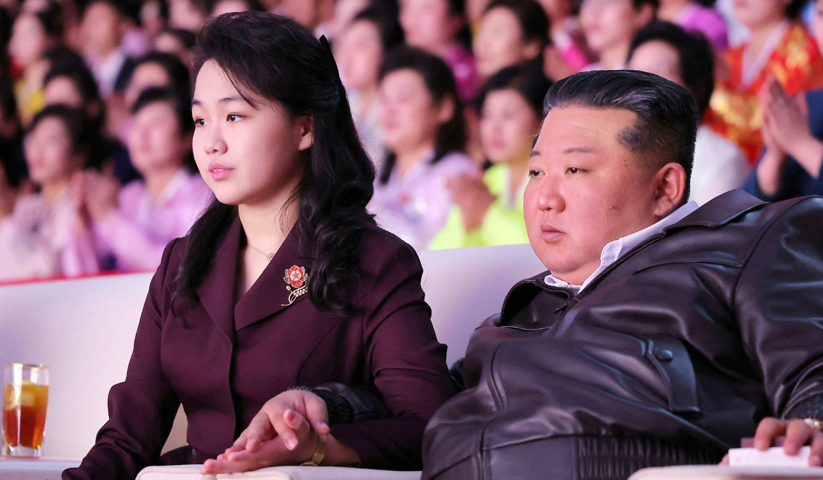 North Korean leader Kim Jong Un (R) and his daughter Kim Ju Ae (L) watching a performance commemorating International Women's Day at the Pyongyang Gymnasium. (AFP)
