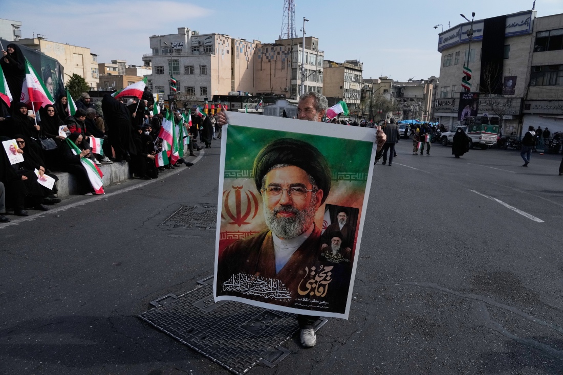 A man holds a poster of Ayatollah Mojtaba Khamenei, who succeeds his late father Ayatollah Ali Khamenei as the supreme leader, during a rally to support him in Tehran, Iran. (AP)