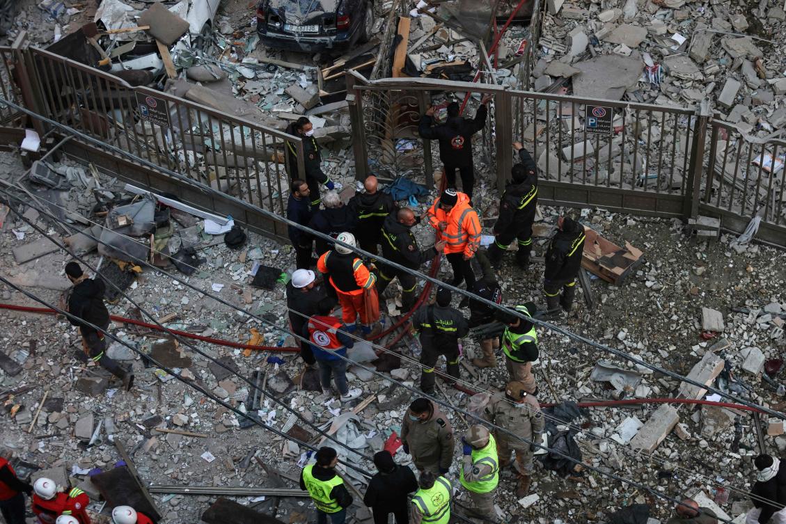 Emergency personnel and residents gather at the site of an Israeli airstrike that targeted a building in the Aisha Bakkar neighborhood of Beirut on Mar. 11, 2026. (AFP)