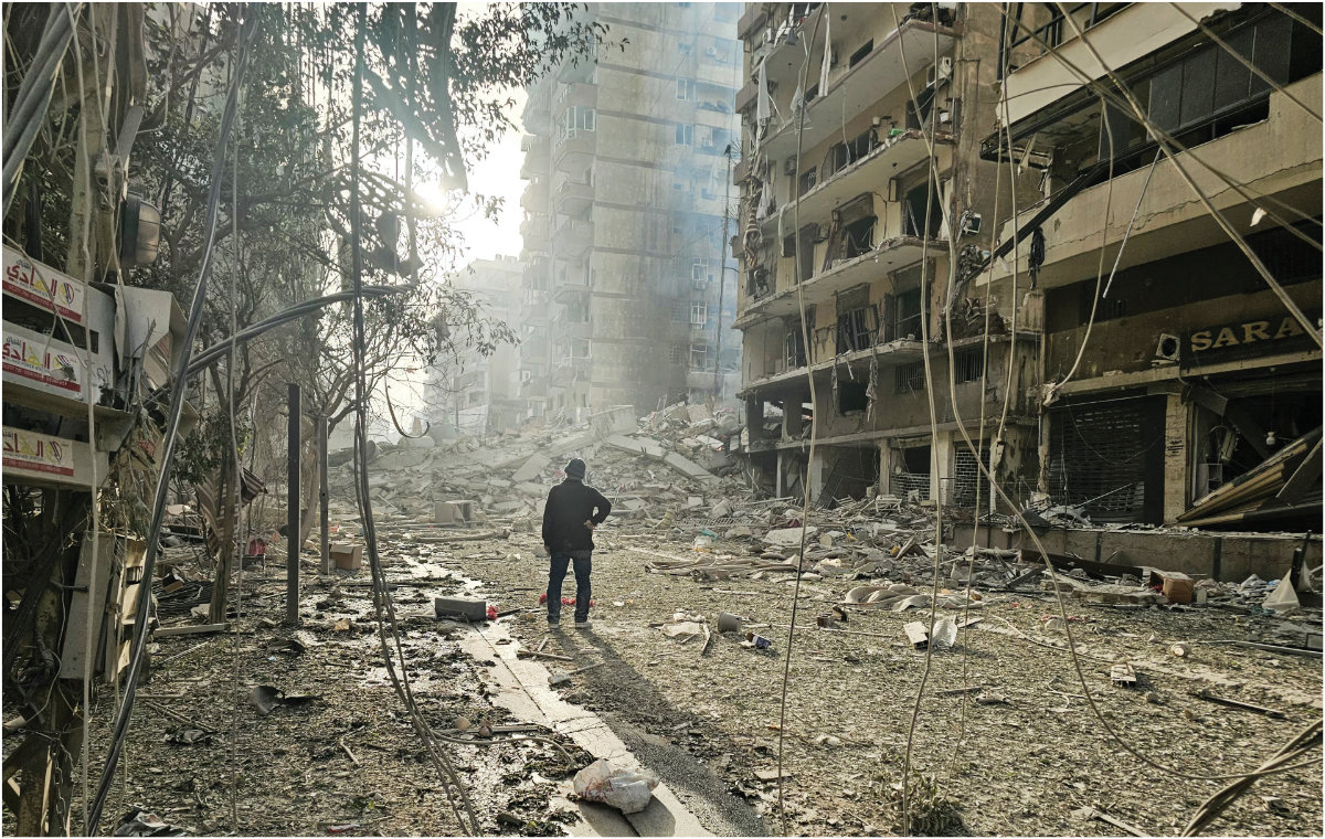 A man looks at the site of overnight Israeli airstrikes in the southern suburbs of Beirut on March 12, 2026. (AFP)