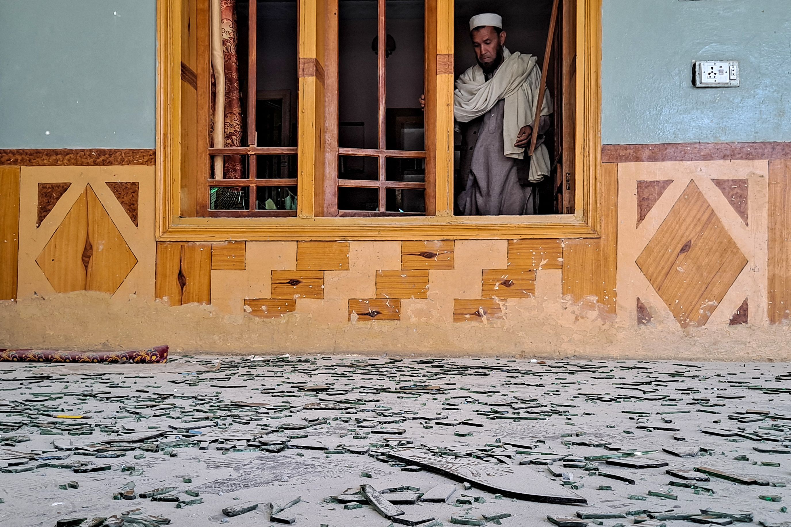 Above, a resident checks the shattered windows of his damaged house near the Torkham border between Pakistan and Afghanistan on March 12, 2026 amid the ongoing clashes between the two countries. (AFP)