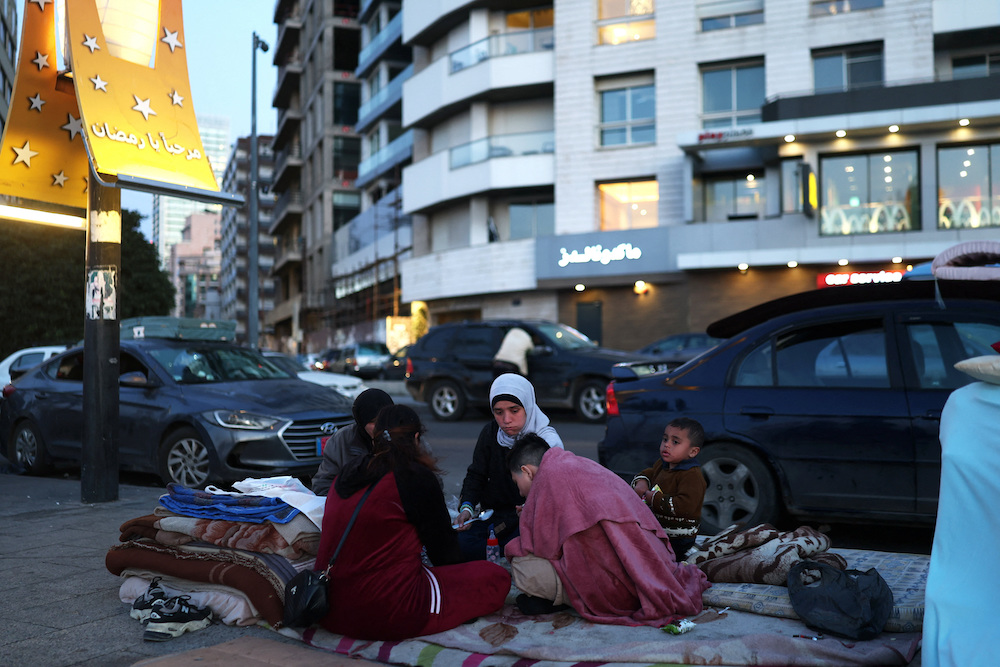 Reem, Fatima, Abd Alkader, Jaafer and Noor break their fast at iftar during Ramadan, as they sit on the street where they have been living following an escalation between Hezbollah and Israel amid the U.S.-Israeli conflict with Iran, in Beirut, Lebanon, March 10, 2026. (Reuters)