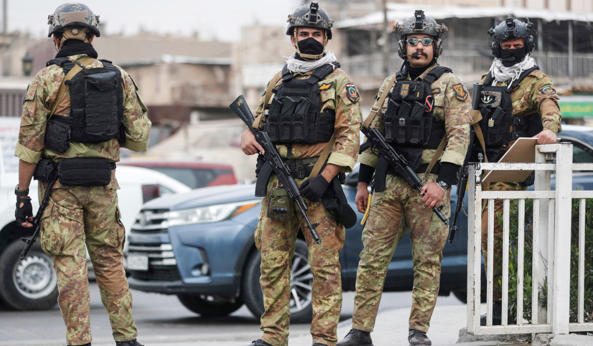 Members of Iraq's Hashed al-Shaabi Forces patrol Baghdad's Tahrir Square on March 12, 2026. (AFP)