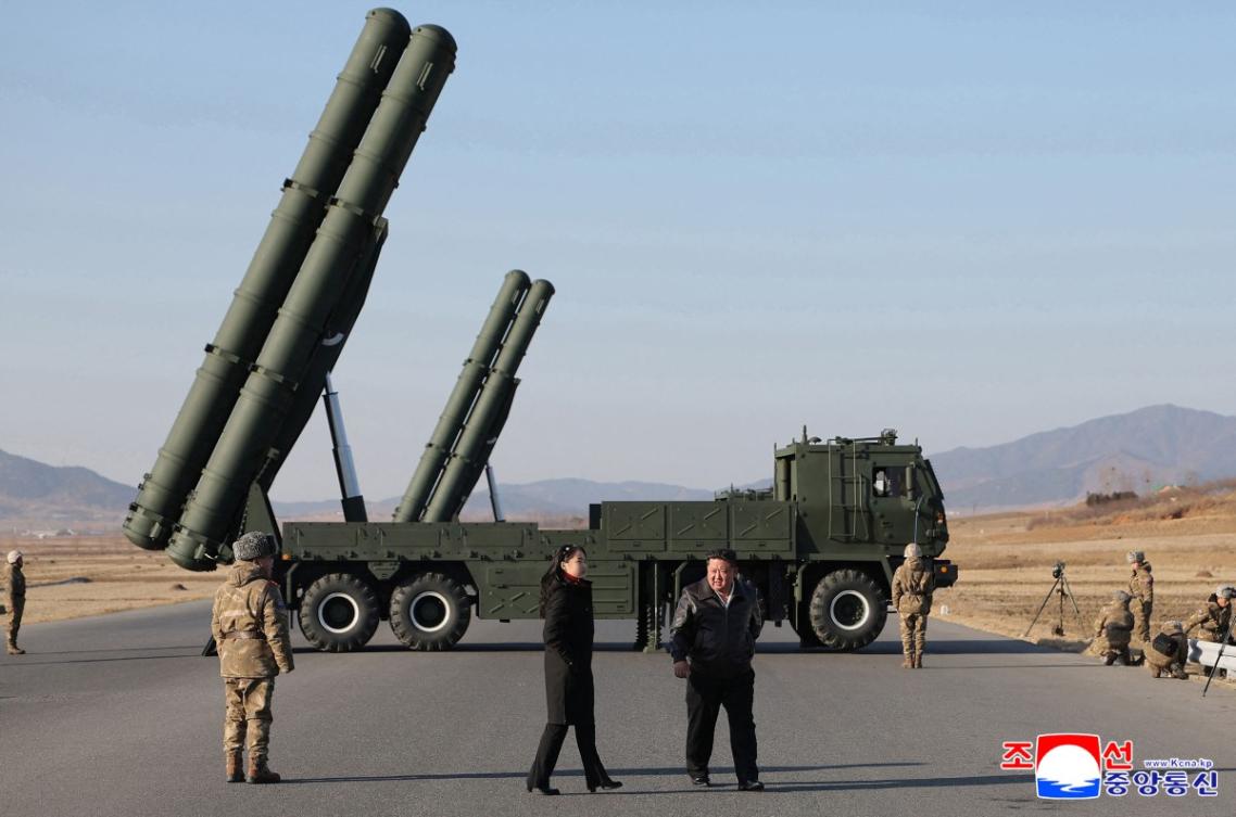 North Korean leader Kim Jong Un, center, and his daughter Kim Ju Ae, second left, inspect a test firing of the renewed large-caliber rocket launcher system at an undisclosed location on Jan. 27, 2026. (KCNA via KNS/AFP)