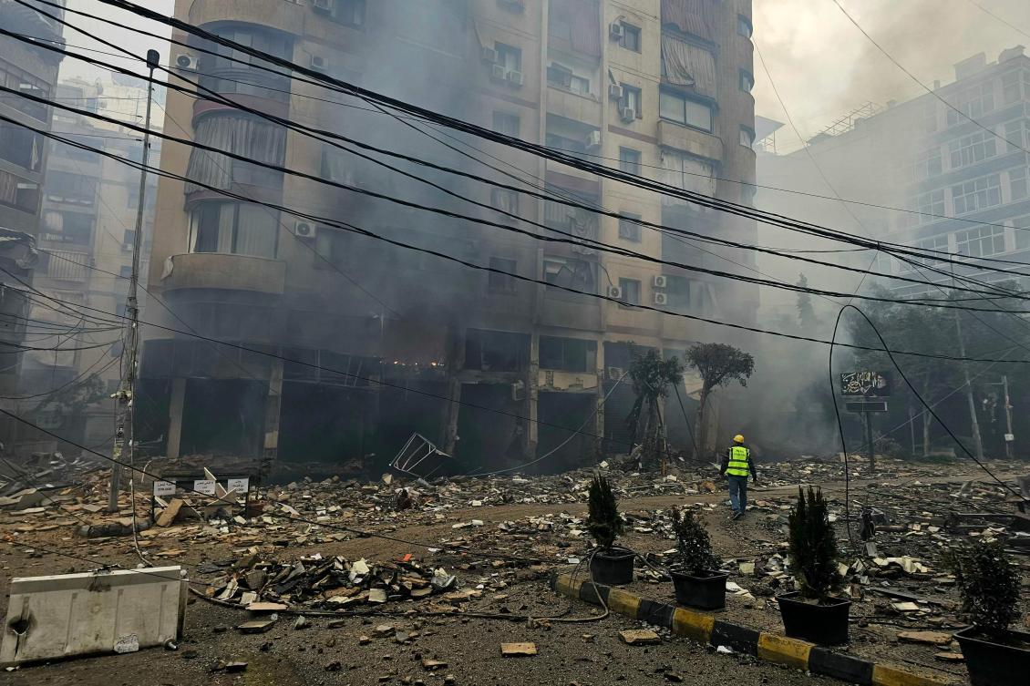 A rescuer arrives at the site of an Israeli airstrike on a residential blocks in Beirut’s southern suburb of Haret Hreik on March 15, 2026. (Photo by AFP)