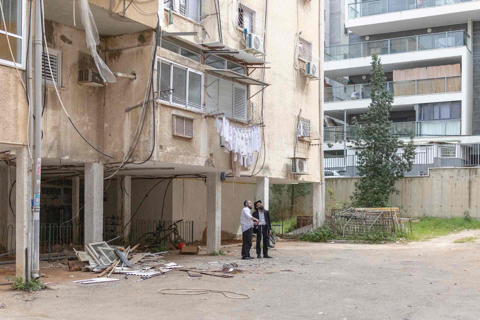 Ultra-Orthodox Jewish men look at the sky in Bnei-Brak, on the eastern outskirts of Tel Aviv, on March 13, 2026. Iran launched a fresh salvo of missiles at Israel on March 13, according to state television, on the 14th day of the Middle East war sparked by US-Israeli strikes on the Islamic republic. (AFP)