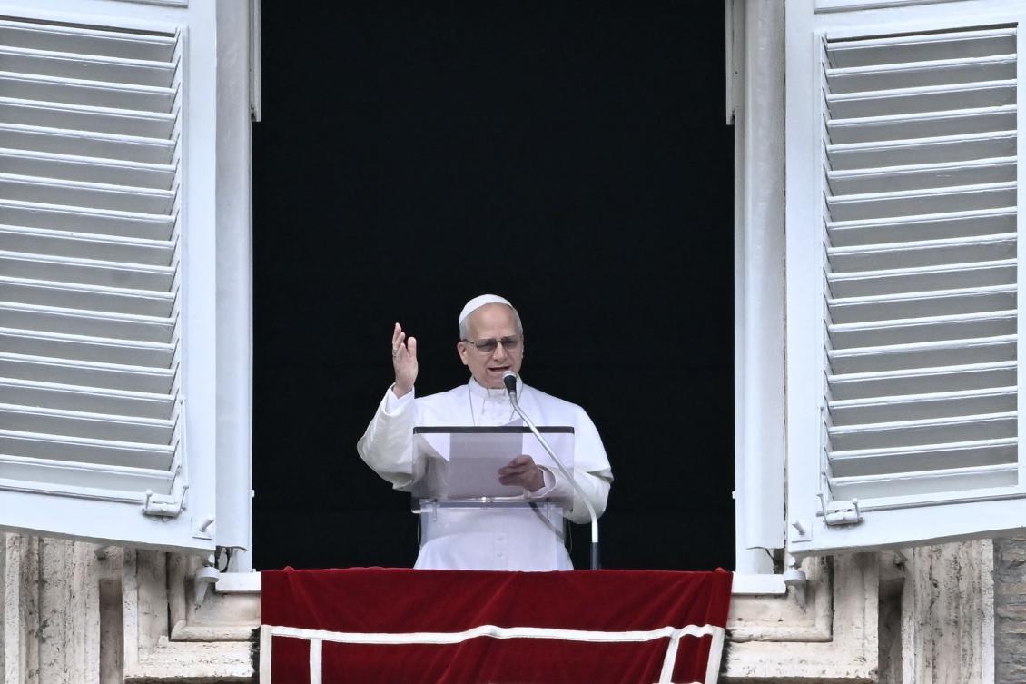 Pope Leo XIV greets the pilgrims gathered in St. Peter's Square during the Sunday Angelus prayer at the Vatican on March 15, 2026. (Photo by Filippo MONTEFORTE / AFP)