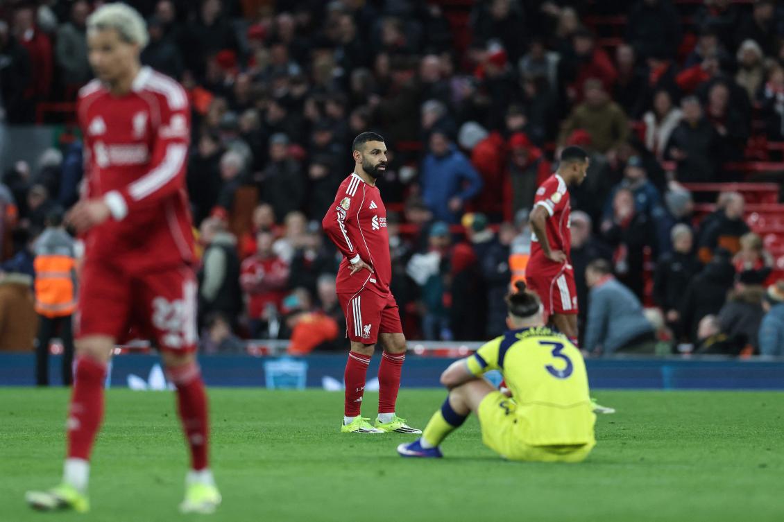 Liverpool’s Egyptian striker Mohamed Salah (C) reacts as the whistle blows at the end of the English Premier League football match between Liverpool and Tottenham Hotspur at Anfield. (AFP)
