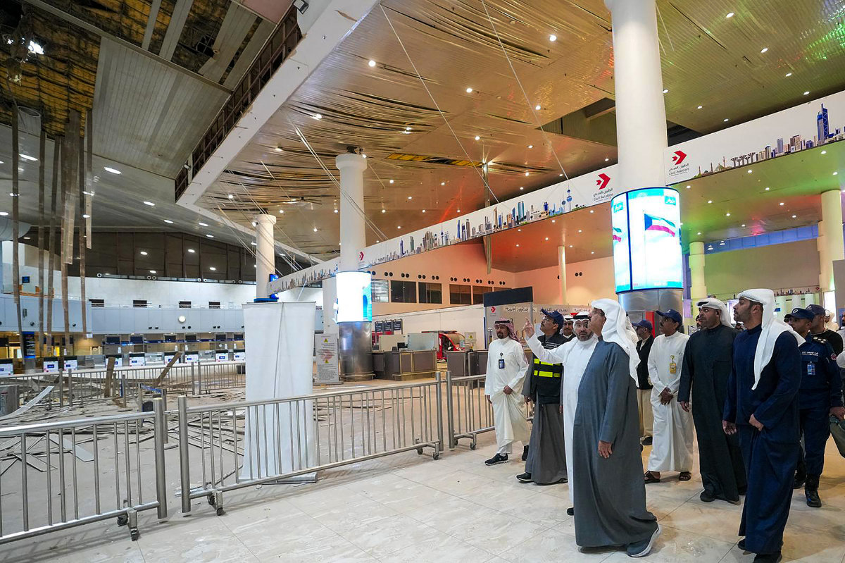 Kuwaiti Prime Minister Sheikh Ahmad al-Abdullah al-Sabah (C) visiting the international airport on March 1, 2026, after it was hit by an Iranian strike in Kuwait City. (KUNA via AFP)