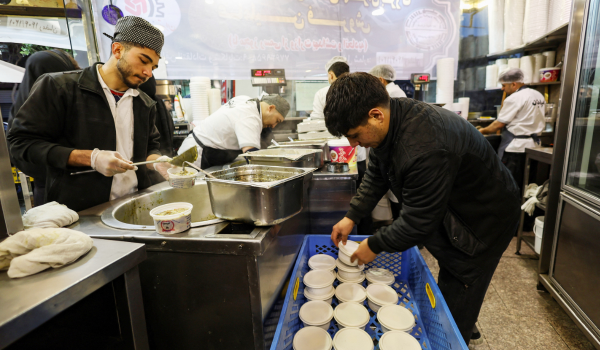 Workers prepare food at a restaurant, amid heightened tensions linked to the U.S.-Israeli conflict with Iran, in Tehran, Iran, March 13, 2026. (REUTERS)
