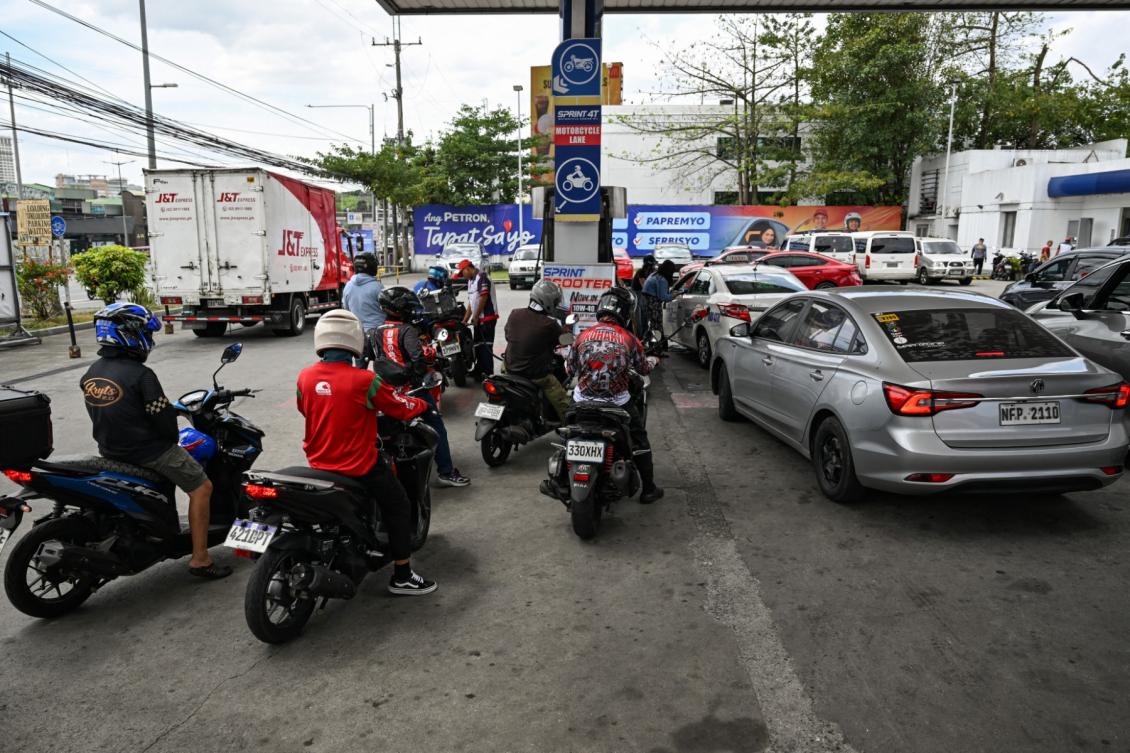 Motorists queue at a gas station amid rising petrol prices in Quezon City, Metro Manila on March 9, 2026. (AFP)