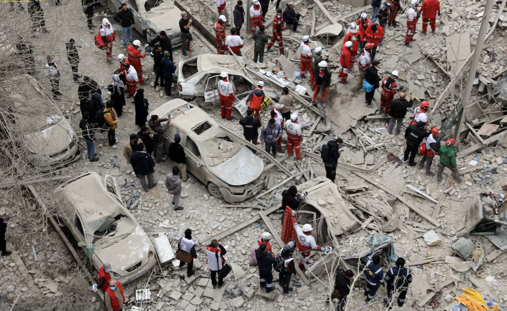 Emergency personnel work at the site of a strike on a residential building, amid the US-Israeli conflict with Iran, in Tehran, Iran, March 16, 2026. (WANA via Reuters)