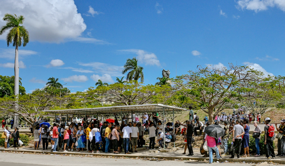People wait at a bus stop in Havana during a blackout on March 16, 2026. (AFP)