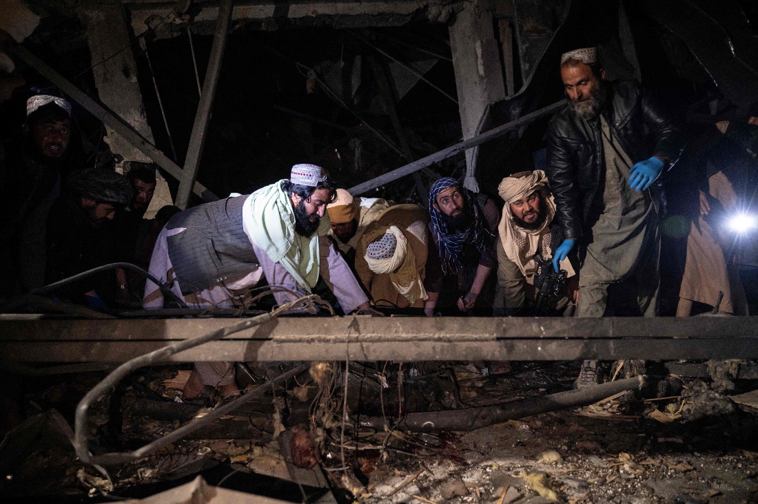 Afghan rescue teams and Taliban security personnel search for bodies under the rubble of a damaged building after Pakistani airstrikes allegedly hit the Secondary Rehabilitation Services, in Kabul, Afghanistan. (AFP)