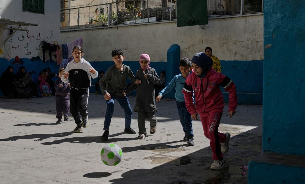 Displaced children fleeing Israeli airstrikes in southern Lebanon and Dahiyeh, Beirut’s southern suburb, play in the courtyard of a school being used as a shelter, Beirut, Mar. 17, 2026. (AP Photo)