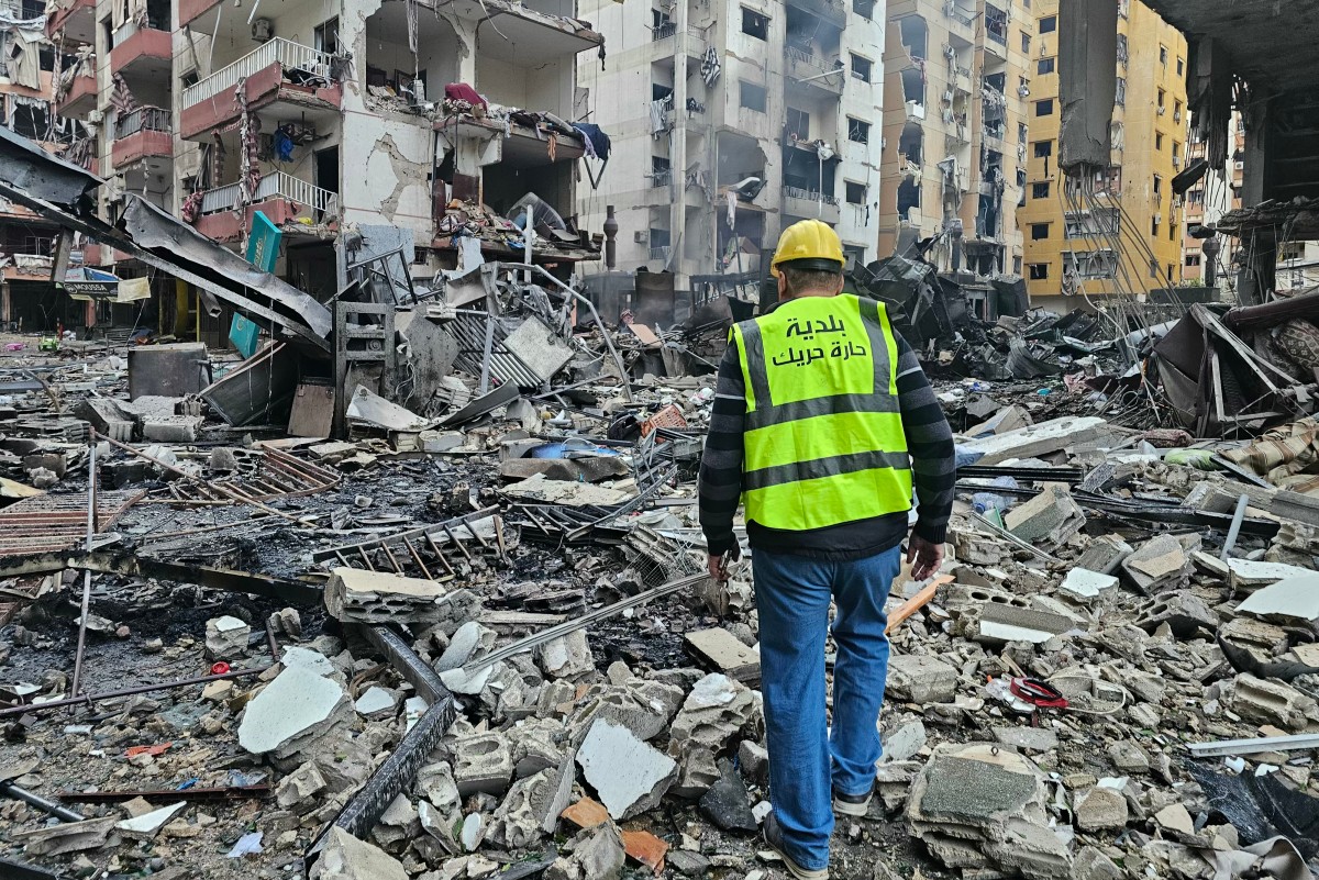 A man inspects a site of overnight Israeli airstrikes in the southern suburbs of Beirut, March 16, 2026. (AFP)