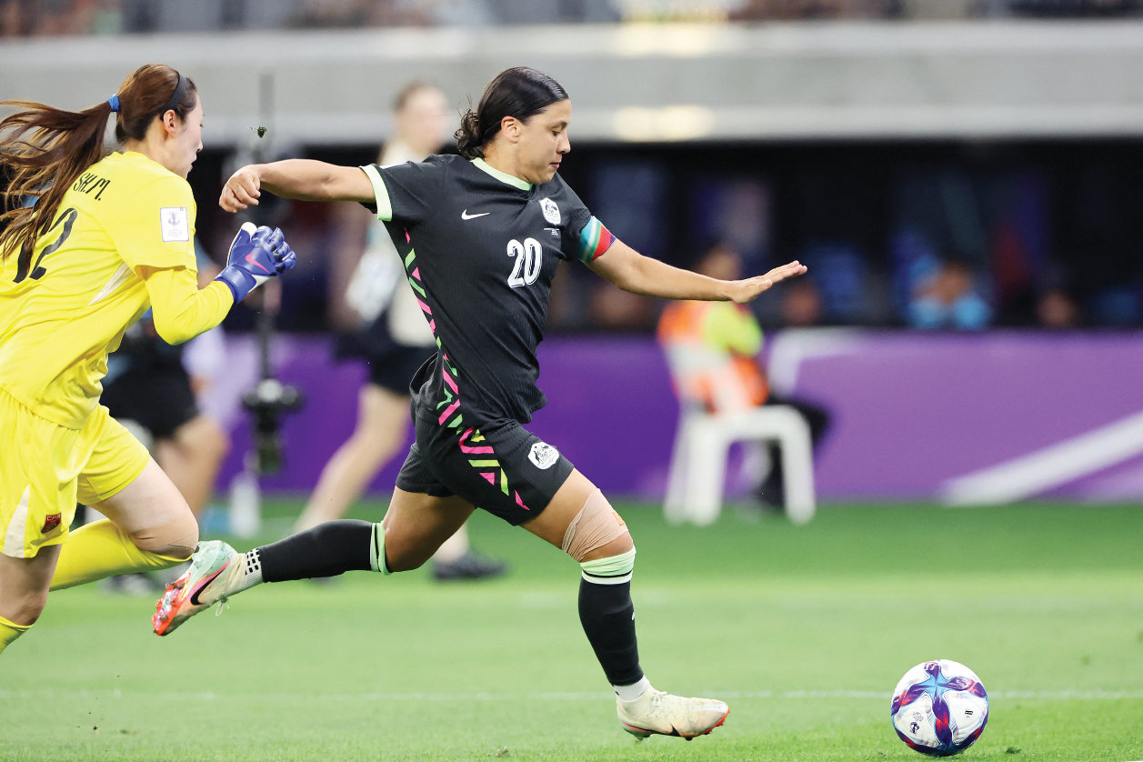 Australia’s Sam Kerr, right, scores a goal during the AFC Women’s Asian Cup semifinal between Australia and China in Perth on Tuesday. (AFP)