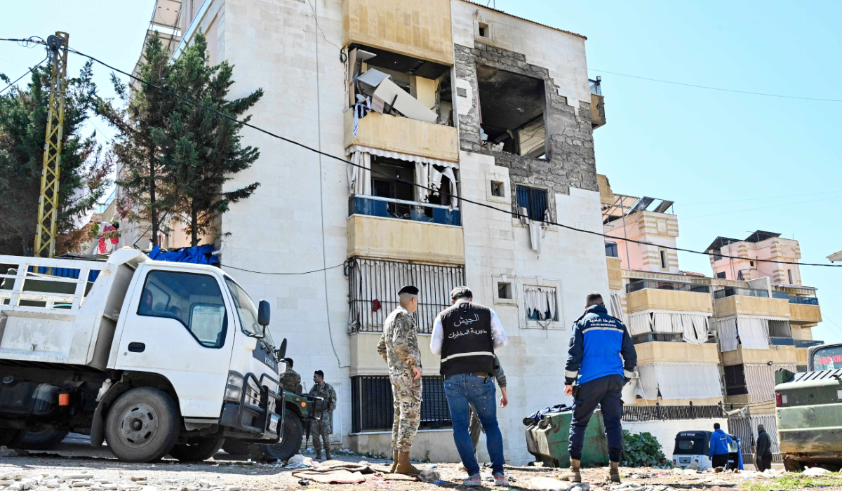 Lebanese army soldiers and police officers inspect a building that was targeted overnight by an Israeli air strike in Khalde, south of the Lebanese capital Beirut, on March 17, 2026. (AFP)