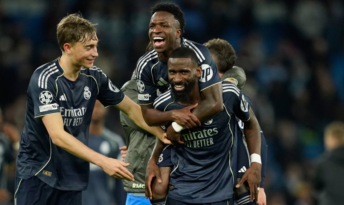 Real Madrid's Vinicius Junior jumps on Real Madrid's Antonio Ruediger after winning the Champions League round of 16 second leg soccer match between Manchester City and Real Madrid in Manchester, Tuesday, March 17, 2026. (AP)