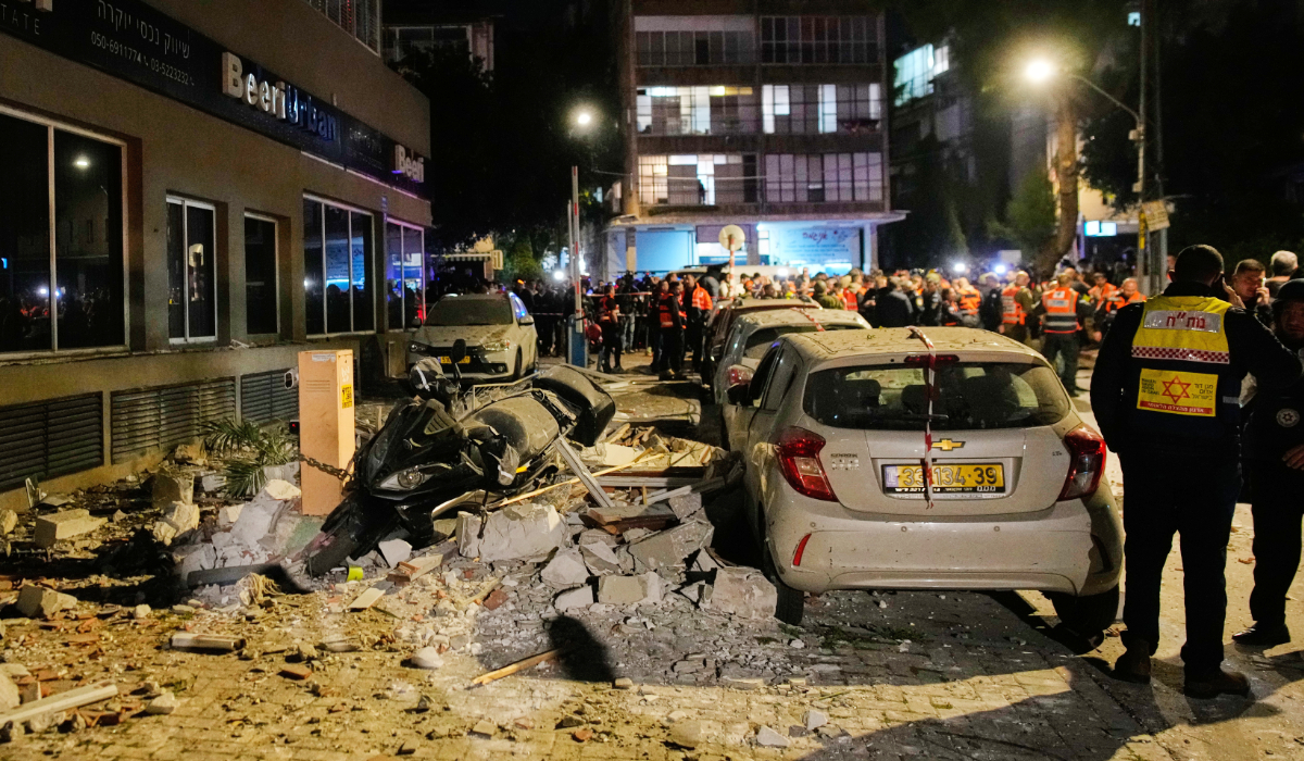 Israeli security forces inspect the site of an Iranian missile strike that killed two people in Ramat Gan, Israel, Wednesday, March 18, 2026. (AP)