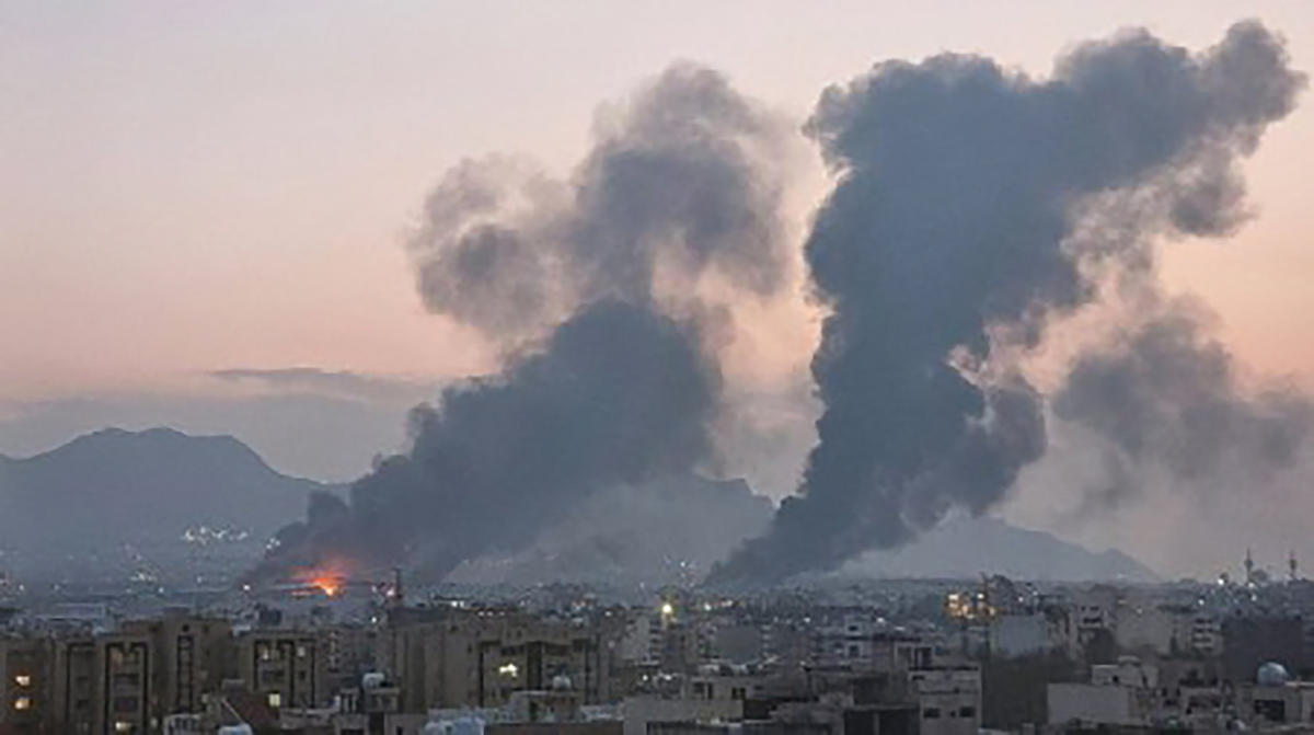 A UGC image posted and shared on social media on March 14, 2026, shows smoke plumes rising over the Iranian city of Isfahan after strikes. (AFP - Source: UGC anonymous)