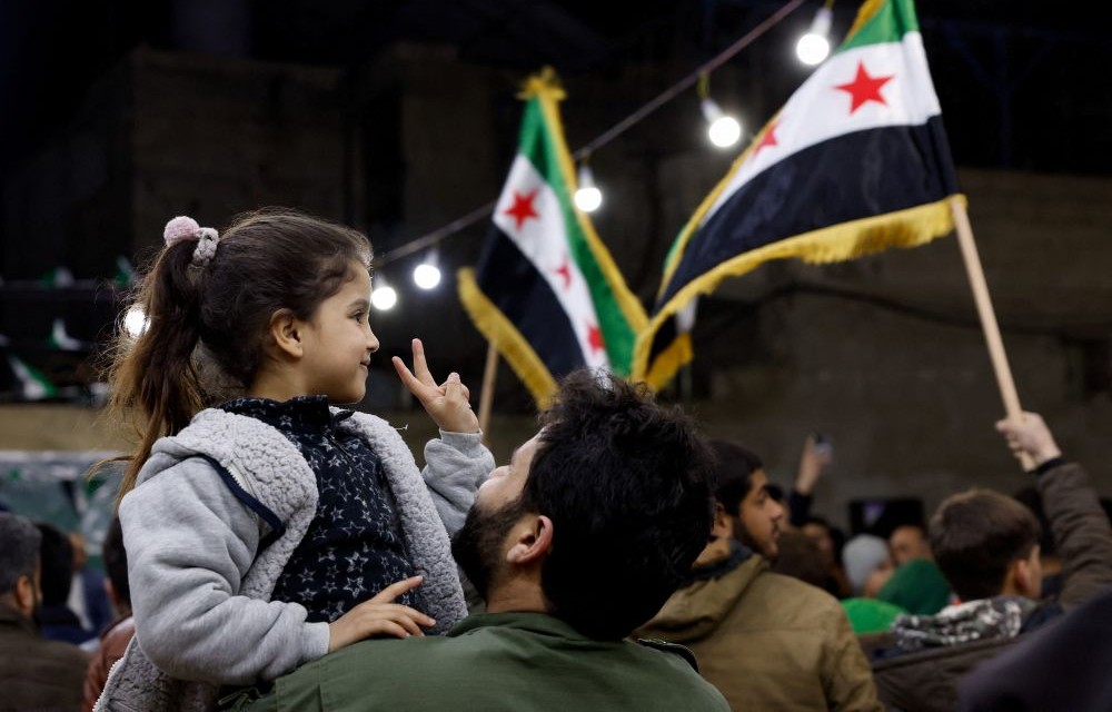 A girl shows a peace sign, as Syrians gather to mark the anniversary of the 2011 uprising against the Assad regime, Damascus, Syria, Mar. 15, 2026. (Reuters)