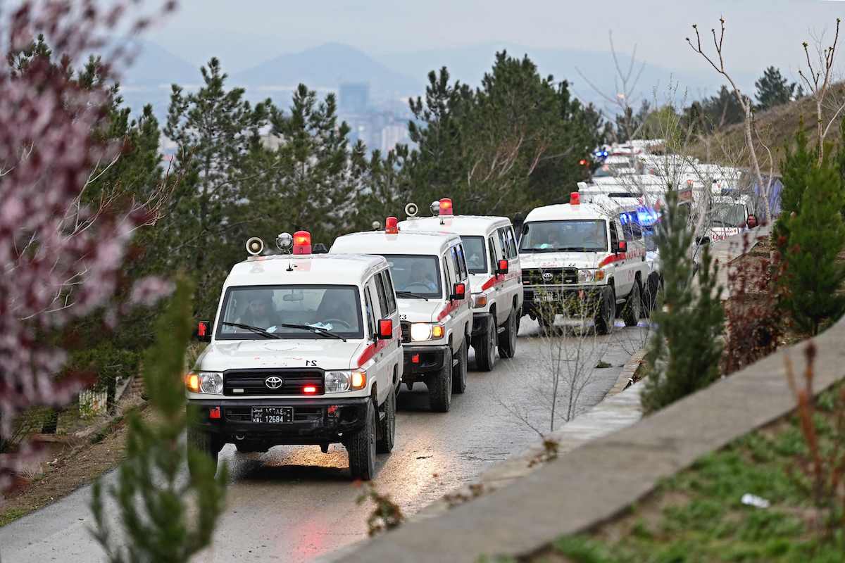 Ambulances carry the bodies of victims of an air strike on a drug rehabilitation center in Kabul for a mass burial on Wednesday. (AFP)