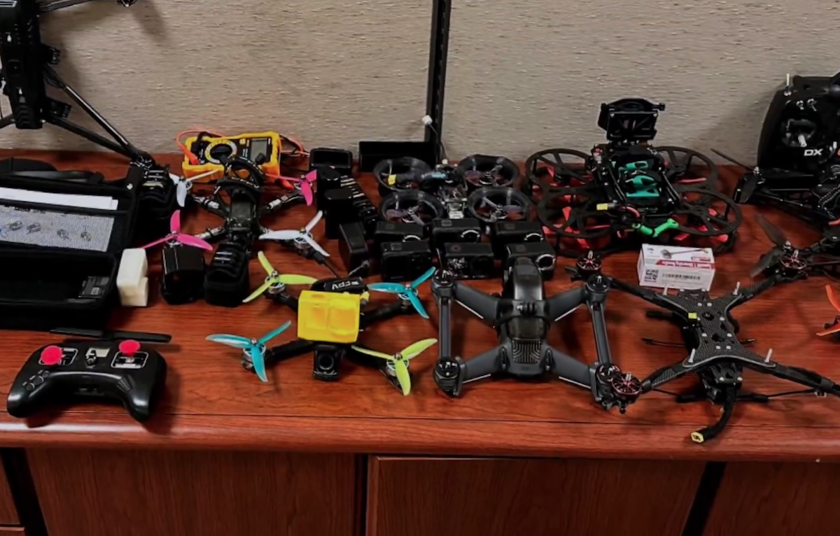 Kuwait's interior ministry shared a video of seized items including Hezbollah flags and small drones. (Screengrab/Kuwait MOI)