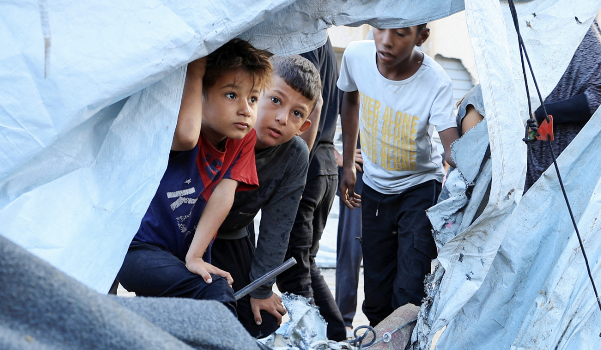 Palestinian children look on at the site of an overnight Israeli strike on a tent, in Gaza City, September 5, 2025. (REUTERS)