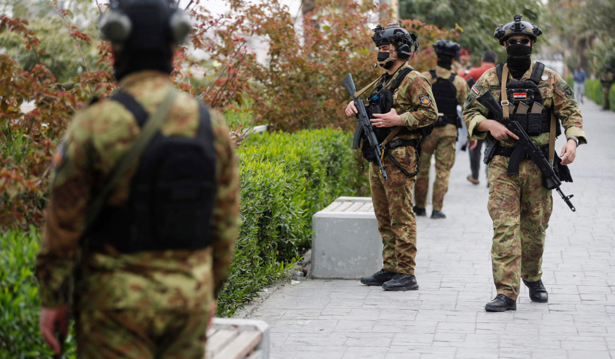 Members of Iraq's Hashed al-Shaabi Forces patrol Baghdad's Tahrir Square on March 12, 2026. (AFP)