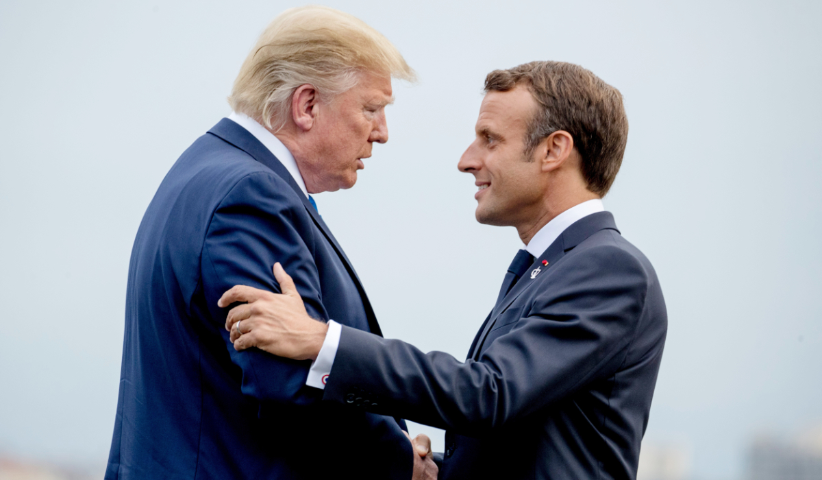 President Donald Trump and French President Emmanuel Macron greet each other at the G-7 summit before a dinner at the Lighthouse of Biarritz, France, Aug. 24, 2019. (AP)