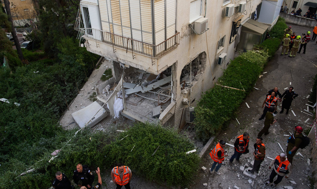 Israeli security forces examine an apartment building that was hit by an Iranian missile in Ramat Gan, Israel, Wednesday, March 18, 2026. (AP)