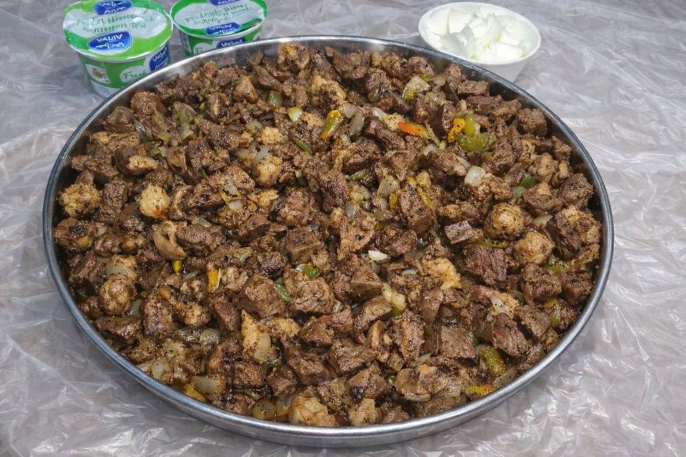 Eid breakfast is a mezze-style spread, often including labneh with mint, olives, pickles, foul, breads and other small dishes, sometimes presented with a modern touch. (Supplied)